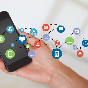 Composite image of hand holding smartphone with smartphone icons